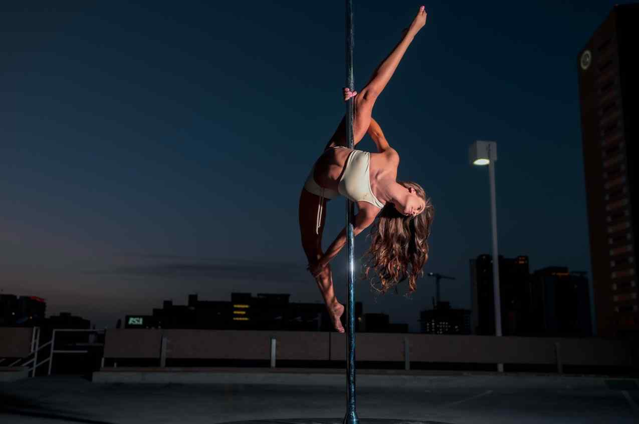 Graceful pole dancer performing an elegant spin