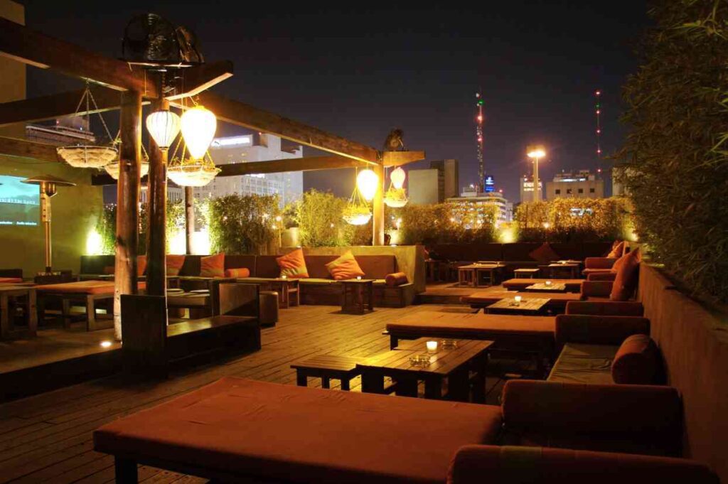 An array of delicious cocktails and appetizers displayed on a rooftop bar